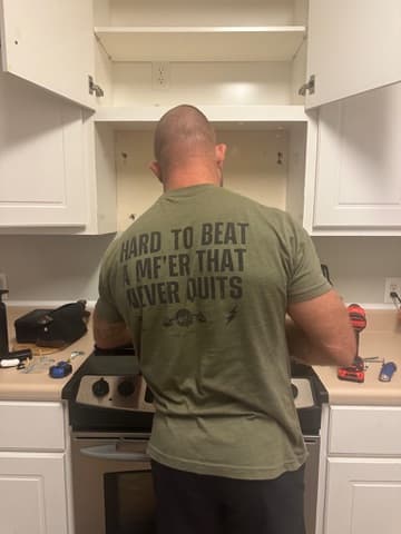 Chris working under a kitchen counter